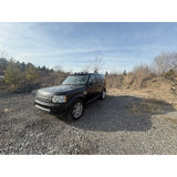 4-light roof pod kit mounted on Land Rover Discovery 3 or 4 with gloss black finish and adhesive no-drill install