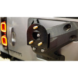 Offset tire carrier for oversized tires