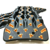 TRED Pro off-road recovery boards with black traction lugs, dual composite construction, and rugged design for sand, mud, and snow